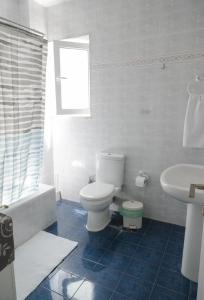 a white bathroom with a toilet and a sink at Sea View Apartment in Chalkida +31 photos