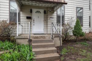 a house with a white door and stairs in front at Shadyside, Pittsburgh !H Modern and Bright Private Bedroom with Shared Bathroom in Pittsburgh