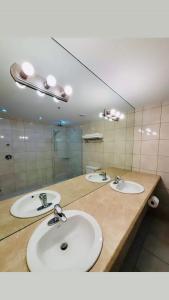 een badkamer met twee wastafels en een grote spiegel bij Spacious King Room at The Franklin Hotel Downtown in St. John's +13 foto's