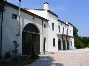 a white building with a gate in front of it at Villa Gaudio in Ponte San Nicolo