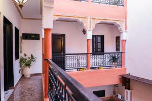 a balcony of a house with orange and white walls at Riad GALFANE in Marrakech