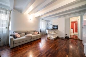 sala de estar con sofá y suelo de madera en Gardastay-Dolly's house, en Riva del Garda