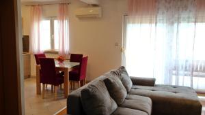 a living room with a couch and a table at Apartment Sarah in Čavle