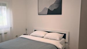 a bedroom with a bed with two pillows on it at Apartment Sarah in Čavle
