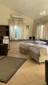 a large bedroom with two beds and a couch at Paraty Bungalows Bar E Hotel in Paraty +46 photos