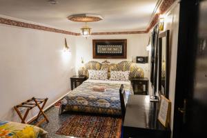 a hotel room with a bed and a couch at Riad GALFANE in Marrakech