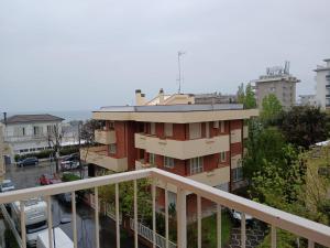 a building with a balcony in a city at Hotel Golino in Rimini
