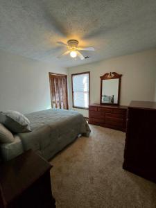 a bedroom with a bed and a ceiling fan at Metro Atlanta 3bed 2 Bath House in Stone Mountain