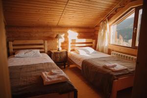 een slaapkamer met twee bedden in een blokhut bij Vidal in Tatariv +90 foto's