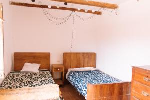 a bedroom with two beds and a dresser at Casa Takiy in Maras