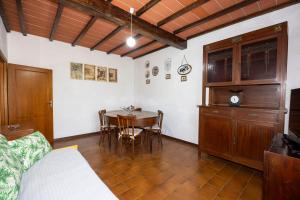 a room with a table and chairs and a bed at Tipica casa nelle Crete Senesi in Monteroni dʼArbia
