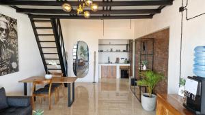 a living room with a table and a mirror at Nice Place To Stay - Rooftop Apartments in Seminyak