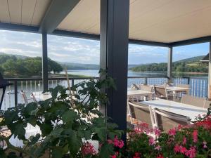 a house with a view of the water and a balcony at LES TERRASSES DU LAC in Chaumard +22 photos