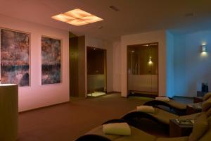 a living room with blue and pink walls and couches at Sternen Hotel Wolfurt in Bregenz