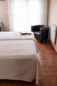 Ein Bett oder Betten in einem Zimmer der Unterkunft Hotel Puerto Arnela