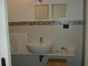 a bathroom with a sink and a mirror and towels at Chicchi Di Melograno in Modica +24 photos