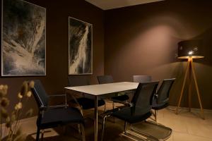 a dining room with a table and chairs at Sternen Hotel Wolfurt in Bregenz