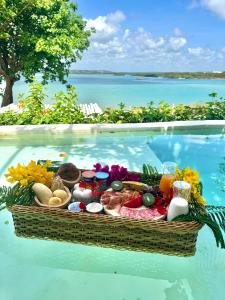 a basket of food in a swimming pool at Pipa Sunset Villa in Pipa