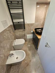 a bathroom with a toilet and a sink at Annade' guest house in Porto Rotondo