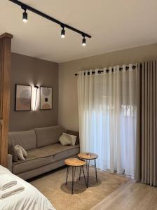 a living room with a couch and a table at 4SeasonsGea , Deluxe Studio , City Centre , Tirana in Tirana