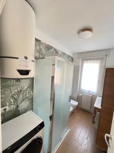a kitchen with a refrigerator and a sink at Casa Rio - Relax on Lake Como with Wi-Fi and Air Conditioning in Colico
