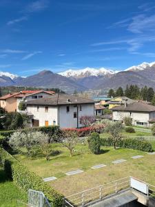 a view of a town with mountains in the background at Casa Rio - Relax on Lake Como with Wi-Fi and Air Conditioning in Colico