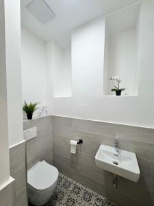 a bathroom with a toilet and a sink at Art Living Vienna in Vienna +58 photos