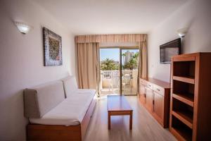 a living room with a couch and a table at Servatur Caribe in Playa de las Americas