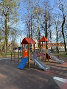 a group of playground equipment in a park at APARTAMENT KASZMIR w KRÓLEWSKIM SANDOMIERZU in Sandomierz