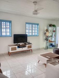 a living room with a flat screen tv on a table at Família munhoz in Cananéia