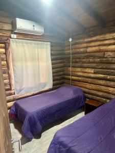 a room with two beds in a log cabin at Naol village in Uspallata +96 photos