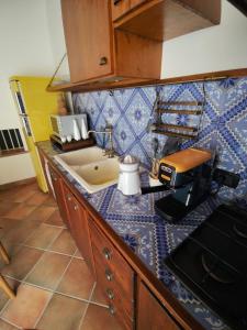 a kitchen counter with a sink and a coffee maker on it at Casa Frufa in Terrasini +47 photos