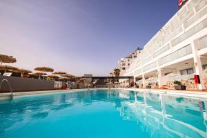 a large swimming pool next to a building at Servatur Castillo de Sol in Puerto Rico de Gran Canaria