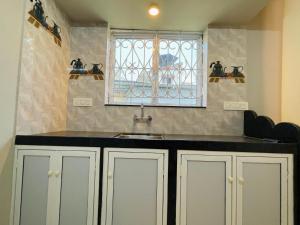 a kitchen with a sink and a window at Blue Horizon 2BHK 5 min Colva Beach in Colva