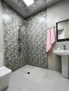 a bathroom with a shower and a toilet and a sink at Soft Villa in Gabala +15 photos