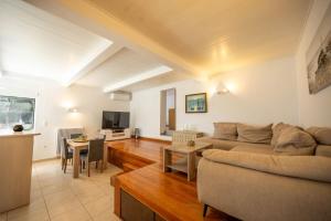 a living room with a couch and a table at Αeraki Villa at Heraion Lagoon in Loutraki