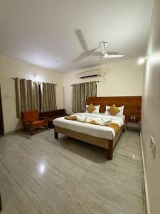 a bedroom with a bed in a room with a ceiling at Atithi farmhouse in Alibaug