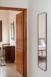 a mirror on a wall next to a door at Rokani Studio I at Kalavrita Center in Kalavrita