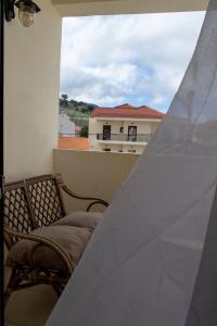 a balcony with two chairs and a view of a building at Rokani Studio II at Kalavrita Center in Kalavrita