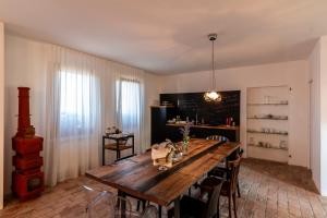 a dining room with a wooden table and chairs at Agriturismo Monte Scala in Taglio di Po