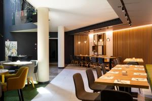 a dining room with wooden tables and chairs at Elite Hotel & Spa in Mestre