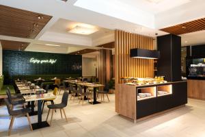 a restaurant with tables and chairs and a chalkboard at Elite Hotel & Spa in Mestre
