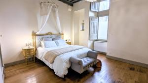 a bedroom with a large bed with a canopy at Boudoir de la Sagesse in Périgueux