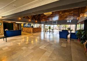 an empty lobby with a large room with wooden ceilings at Grand Heights Hotel in Murree
