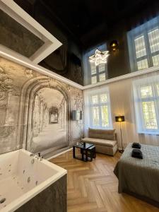 a large room with a bath tub and a bed at Sky Mirror jacuzzi in Kraków