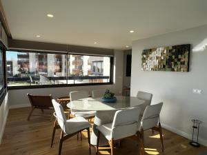 a dining room with a table and chairs at FLH Cascais Atrium Luxury Apartment with Sea View and Pool in Cascais