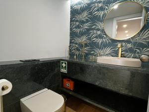 a bathroom with a sink and a mirror at FLH Cascais Atrium Luxury Apartment with Sea View and Pool in Cascais