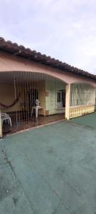 a house with a porch with a table and a chair at Casa para Cop30 in Belém +3 photos