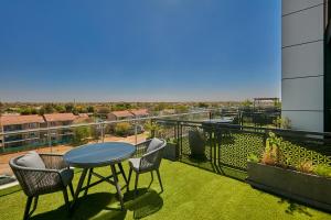 a patio with a table and chairs on a balcony at Hotel 430 in Gaborone