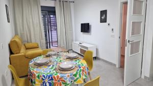 a living room with a table and chairs and a room at Gran terraza Apartamento playa Garrucha in Garrucha